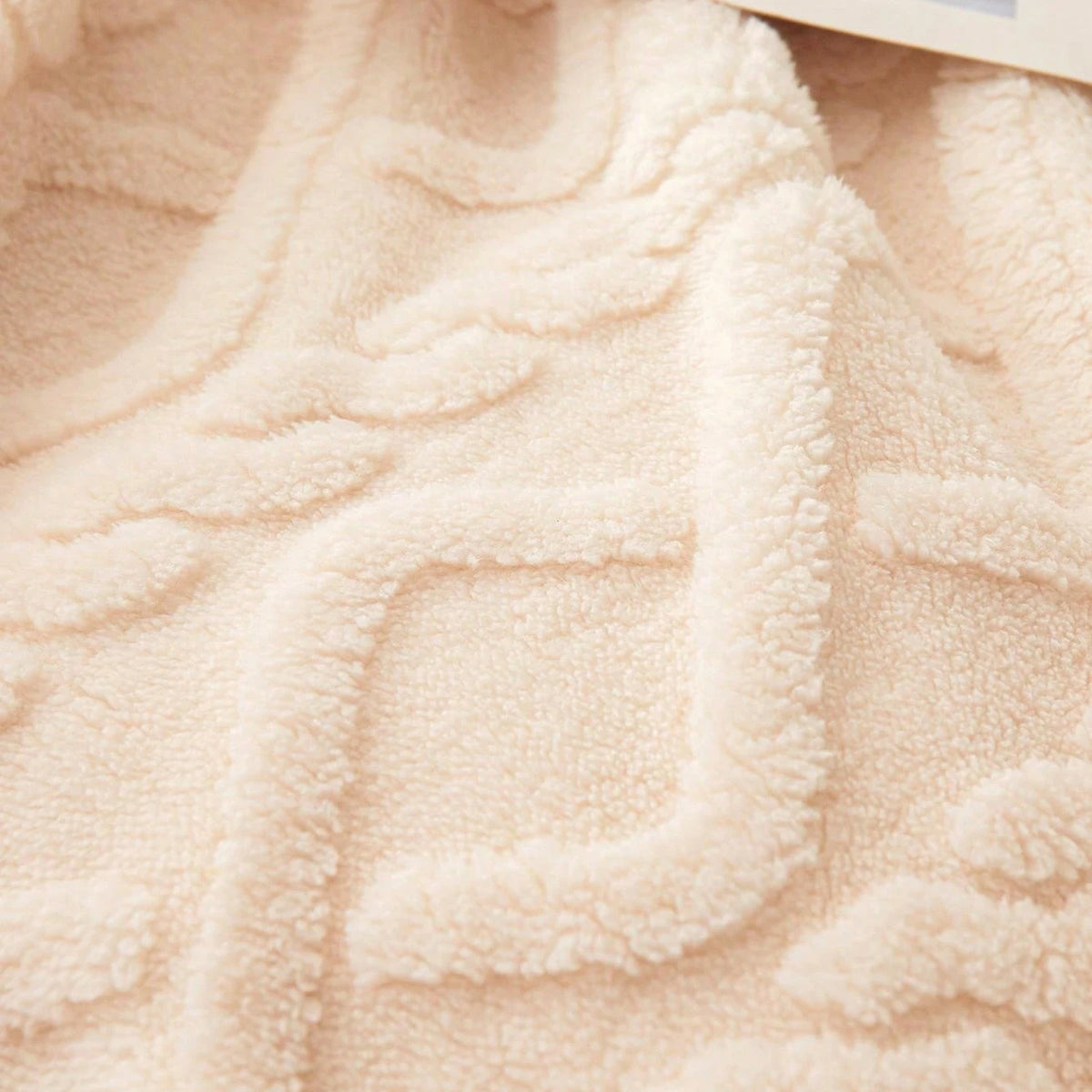 Close view of the Featherweight Throw’s raised geometric texture.