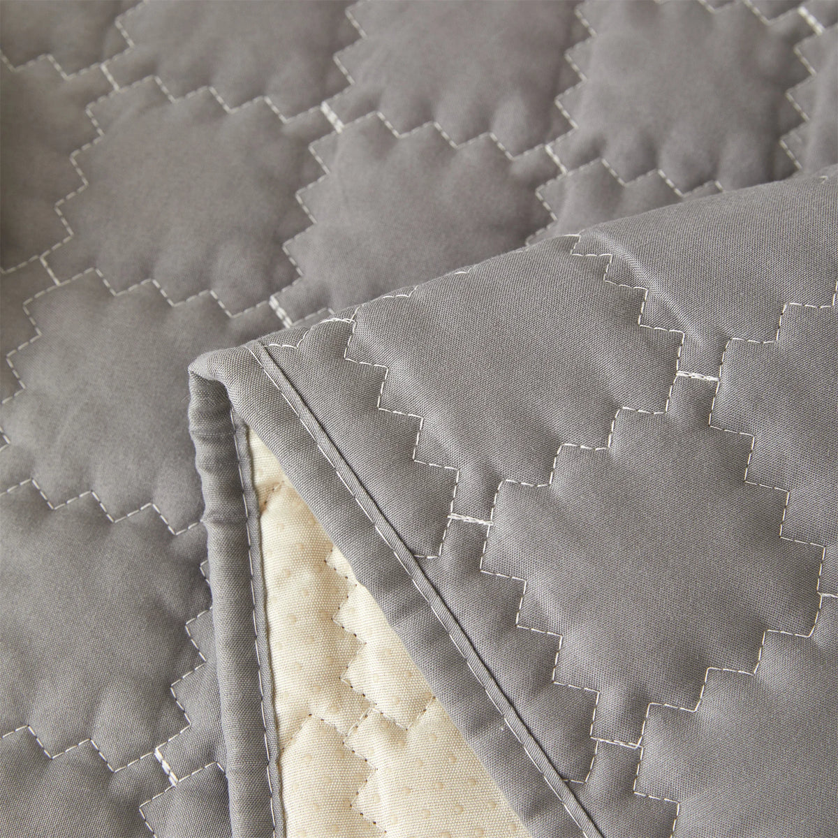 Close-up of the dark grey quilted polyester and non-slip backing