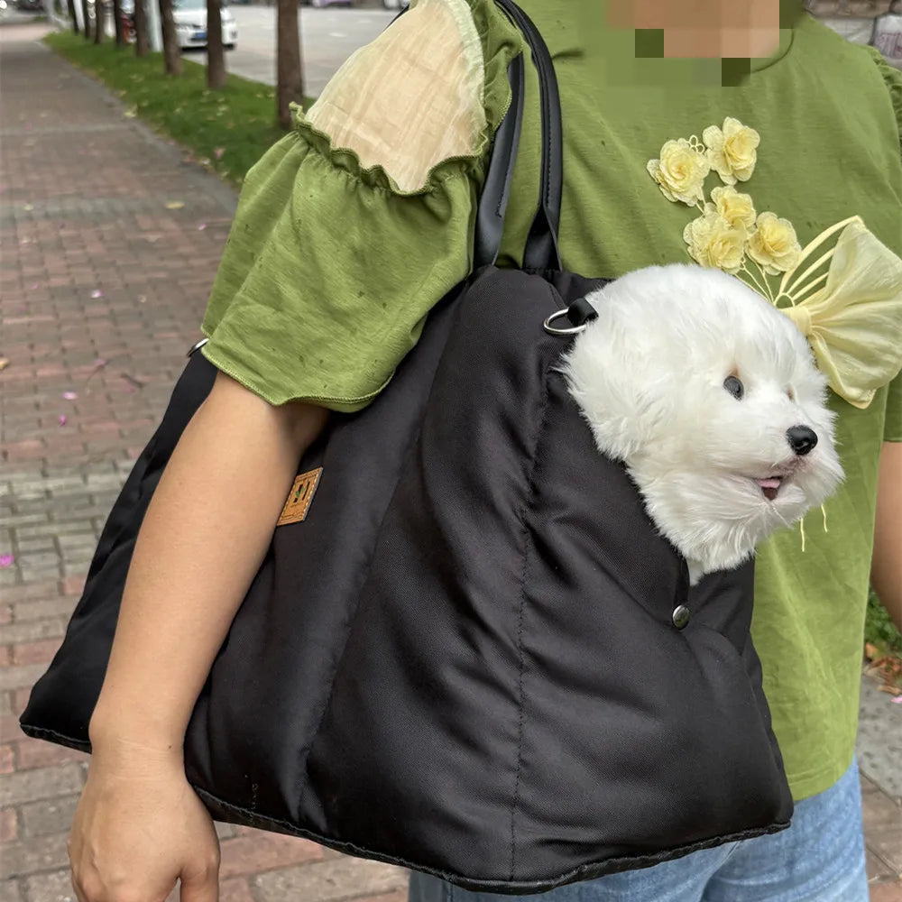 Black Convertible Nest pet carrier worn over the shoulder