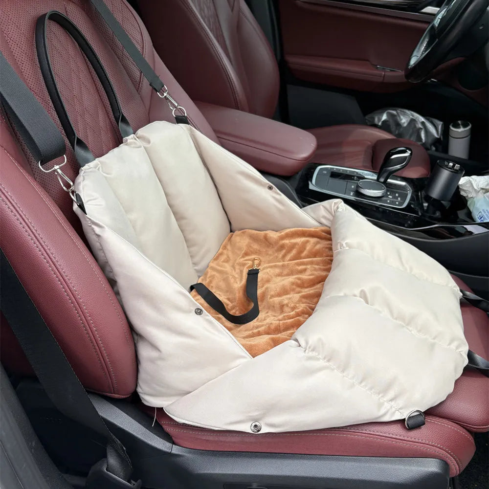 Beige Convertible Nest car seat setup with reversible cushion and harness tether