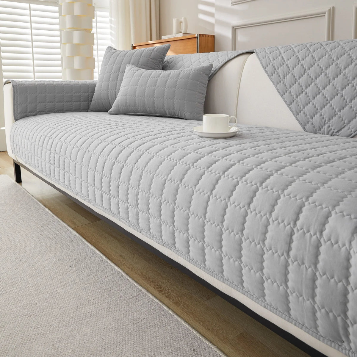 Light grey quilted sofa panels covering the seat, back, and arms