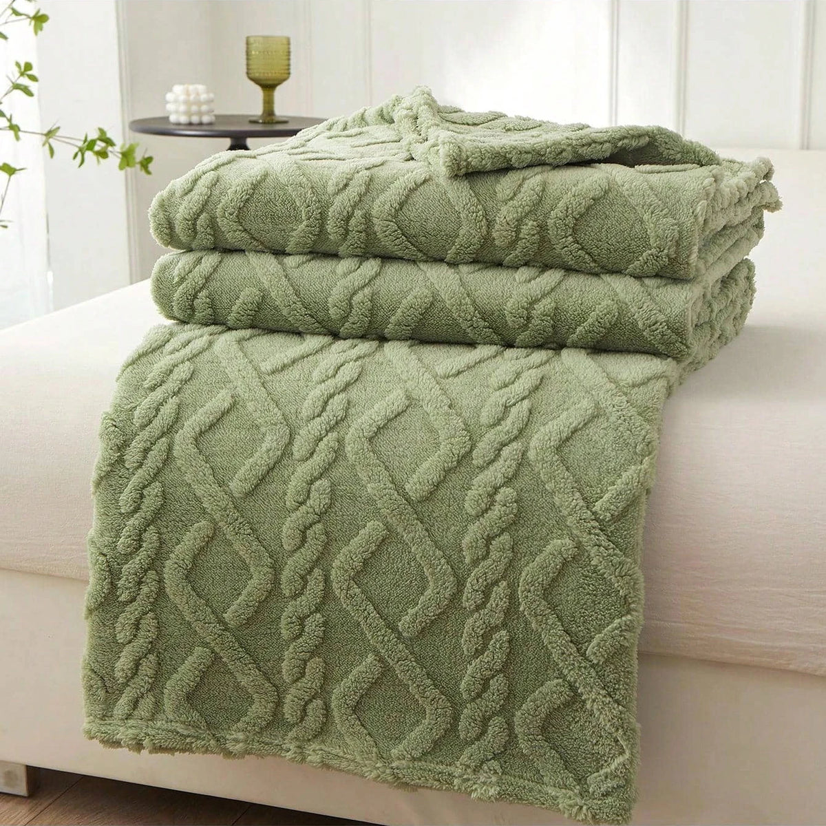 Green Featherweight Throw with a raised geometric texture.