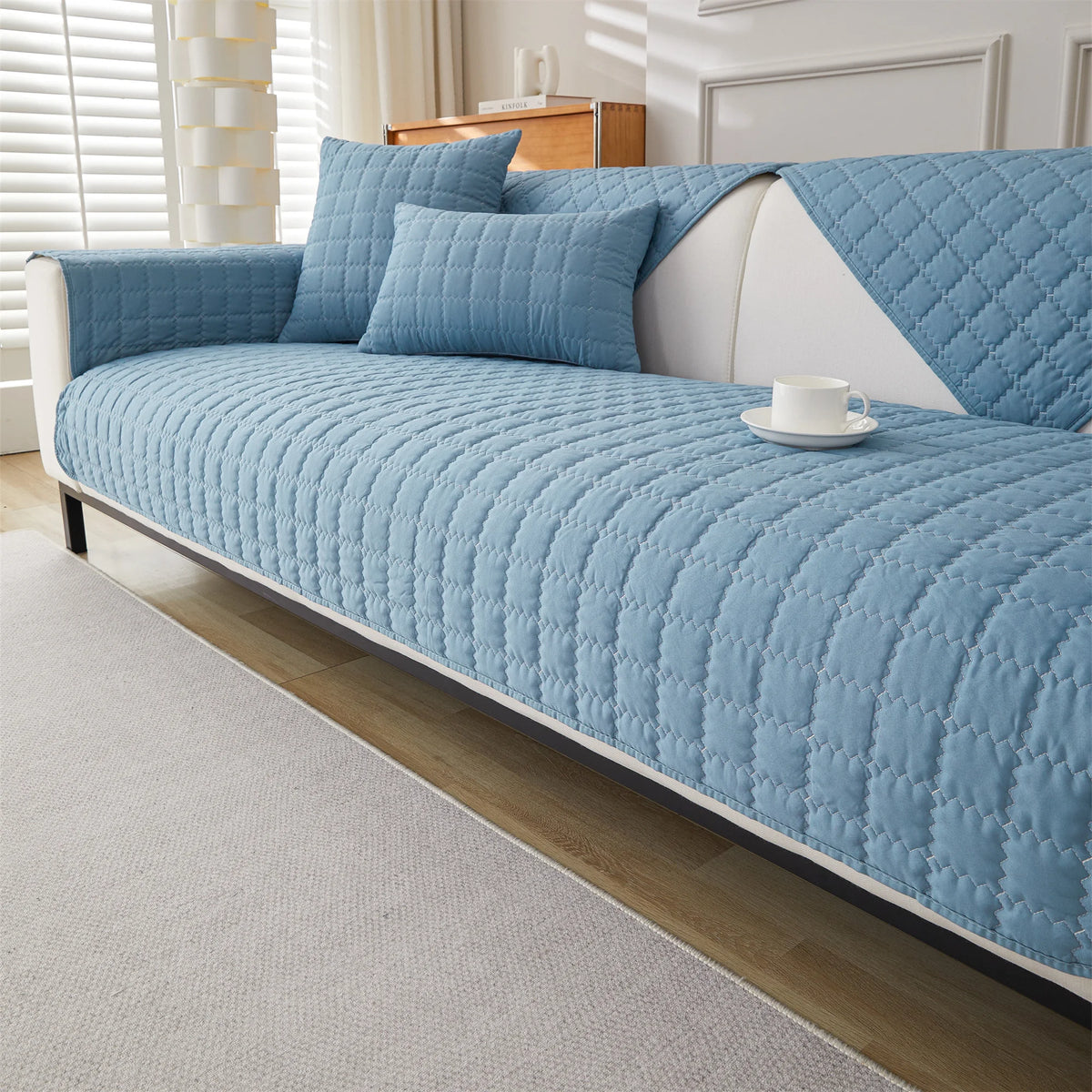 Sky blue quilted sofa panels covering the seat, back, and arms