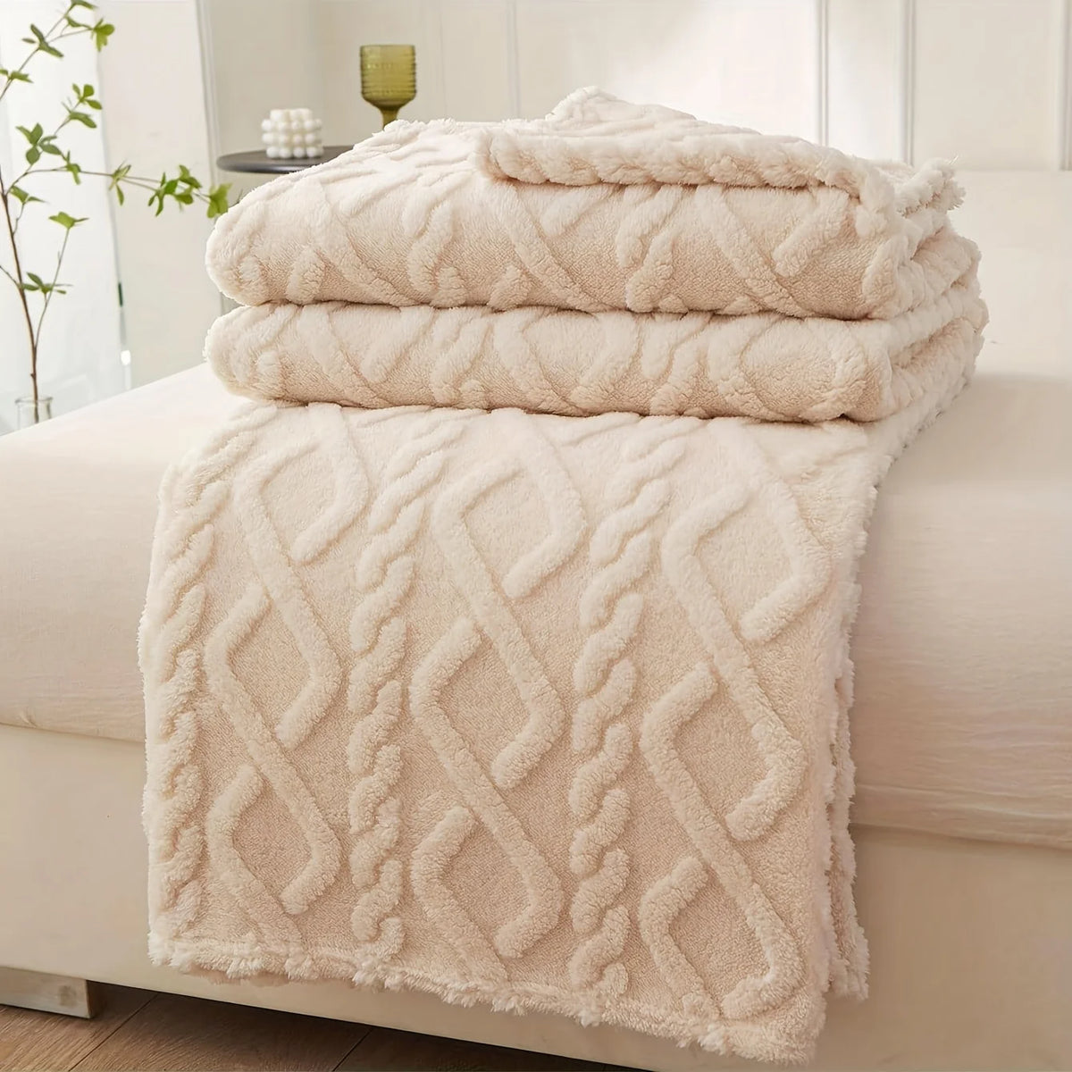 Beige Featherweight Throw draped across a sofa in a bright living room.