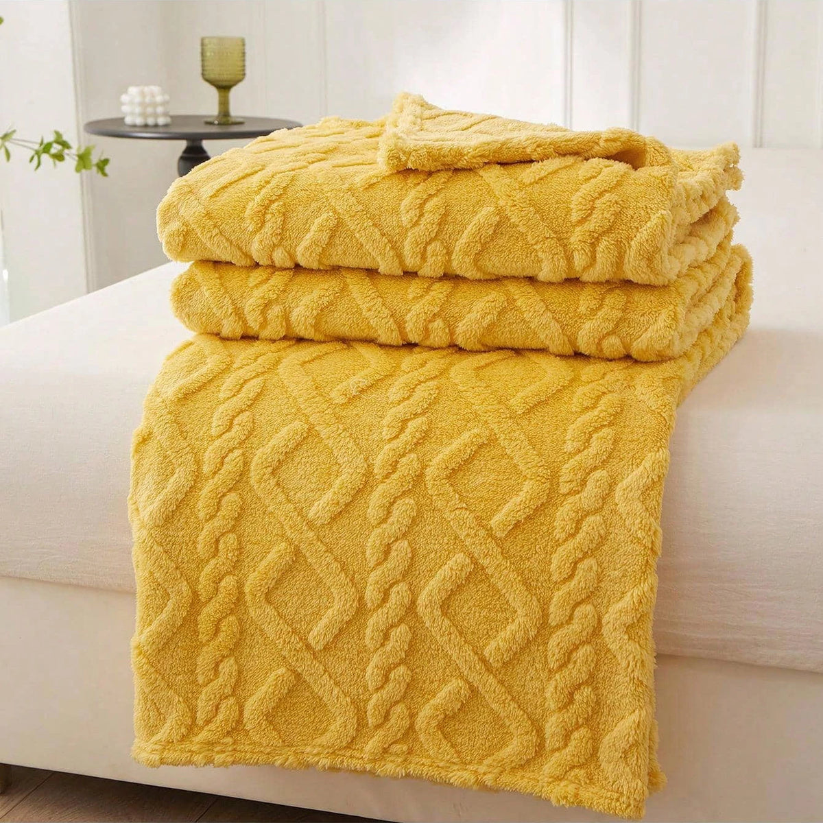 Yellow Featherweight Throw with a raised geometric texture.