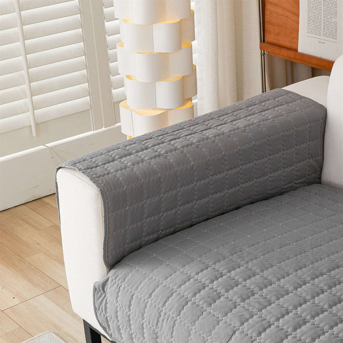 Dark grey quilted panel draped over a sofa arm