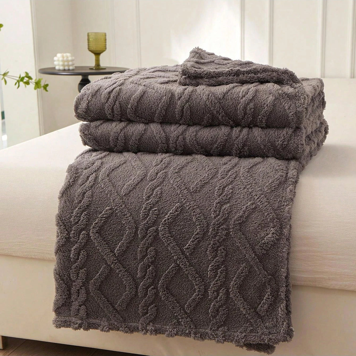 Gray Featherweight Throw with a raised geometric texture.