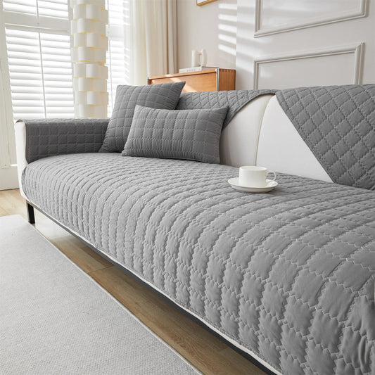 Dark grey quilted sofa panels covering the seat, back, and arms