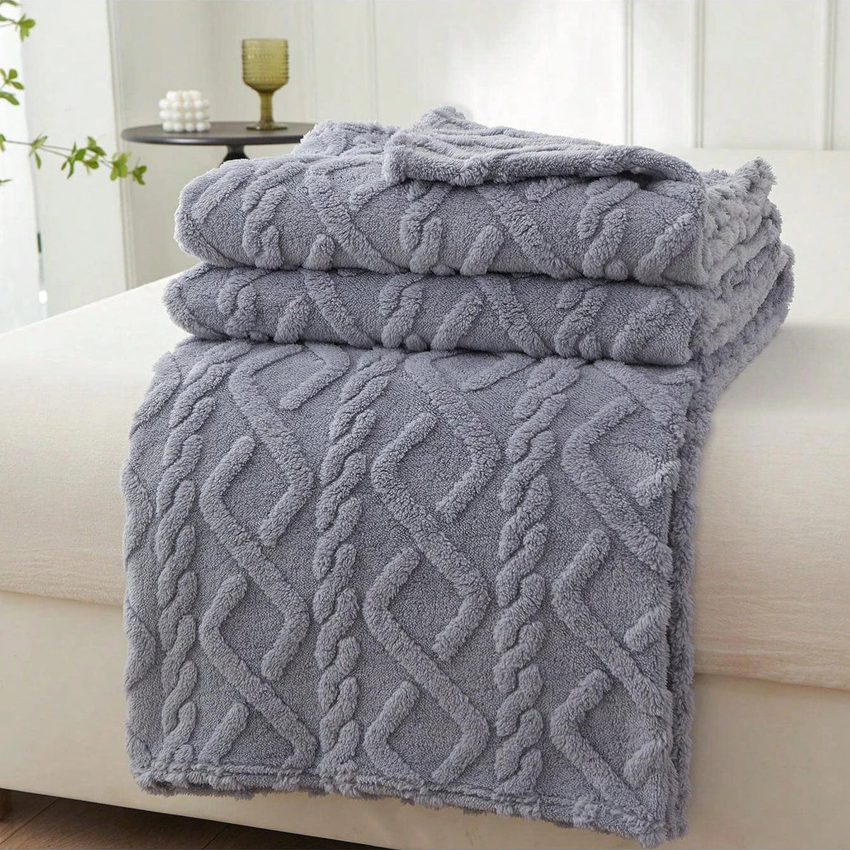 Blue Featherweight Throw with a raised geometric texture.