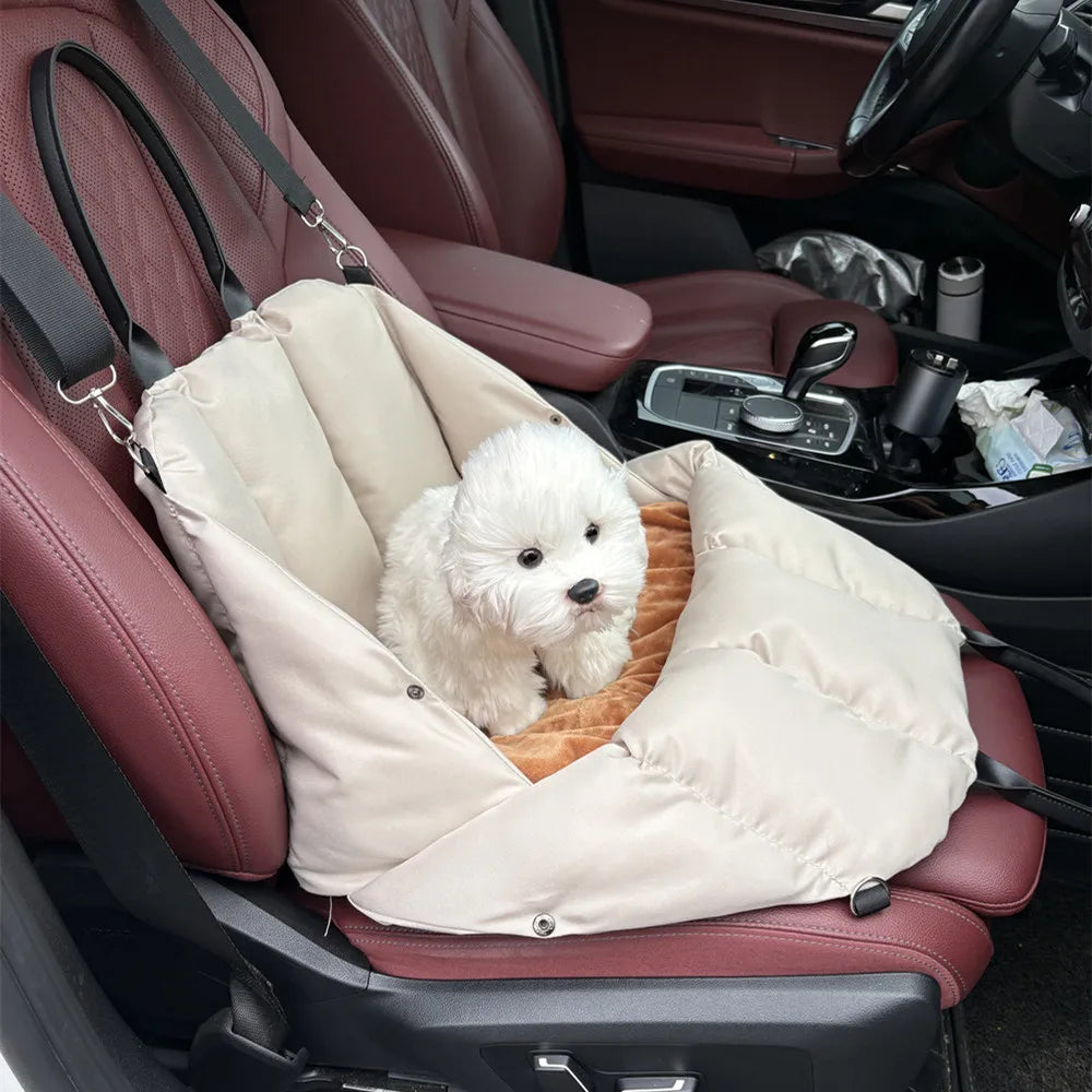 Beige Convertible Nest pet carrier secured on a car seat with a small dog