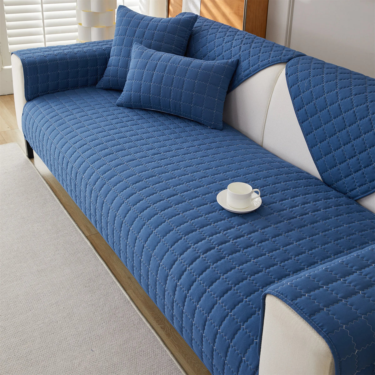 Deep blue quilted sofa panels covering the seat, back, and arms
