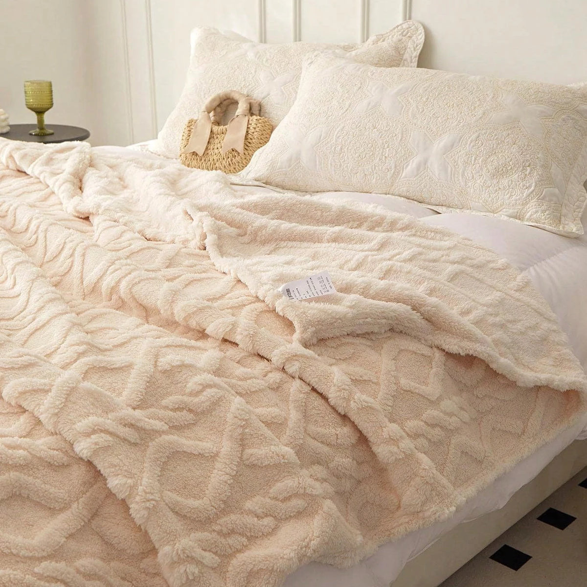 Folded coral-fleece throw blankets showing their soft textured finish.