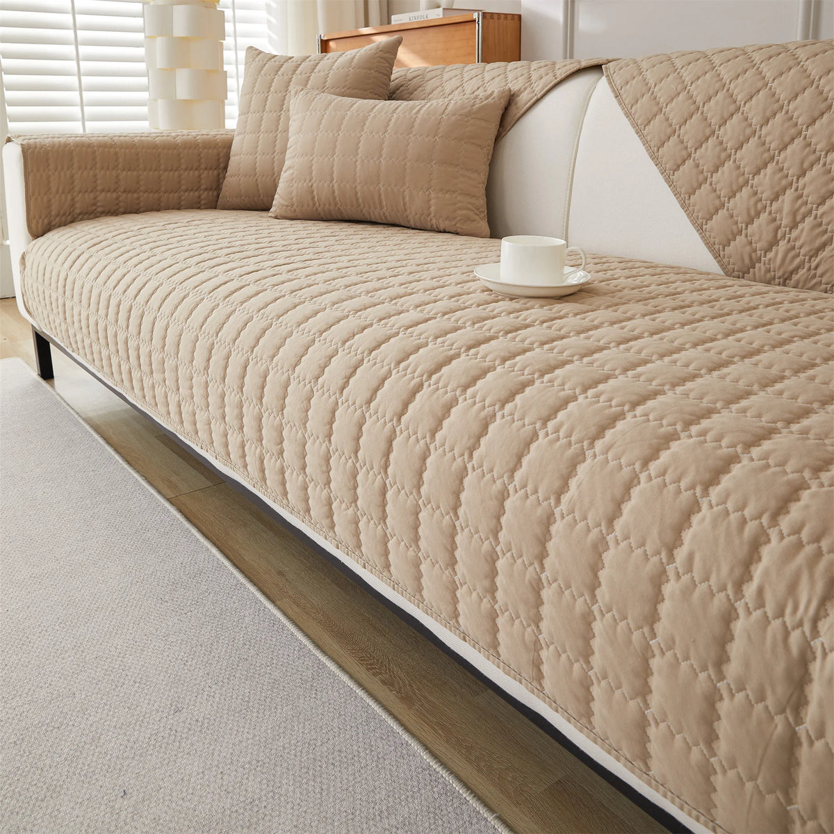 Sand quilted sofa panels covering the seat, back, and arms