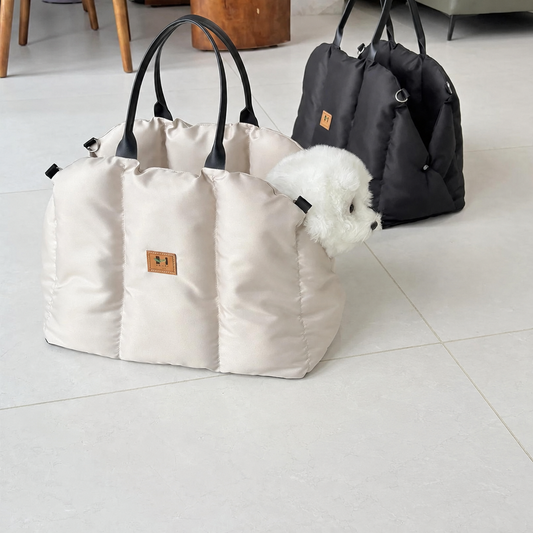 Beige and black Convertible Nest pet carriers with a small white dog