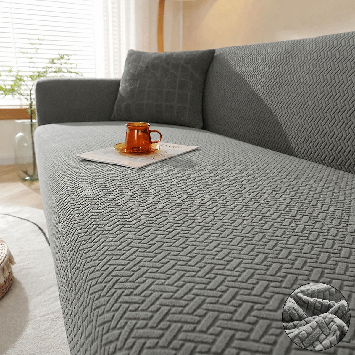 Grey textured Fireside Sofa Cover on a couch in a bright living room